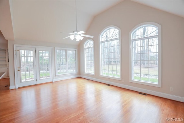 unfurnished sunroom with lofted ceiling, a wealth of natural light, and ceiling fan