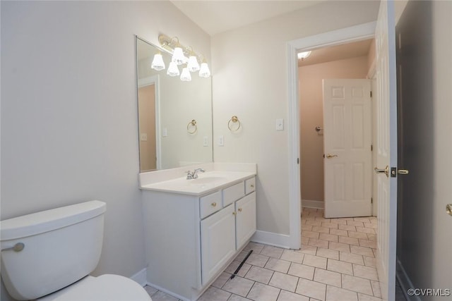 bathroom with vanity, tile patterned flooring, and toilet