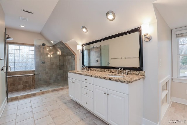 bathroom with lofted ceiling, vanity, and an enclosed shower