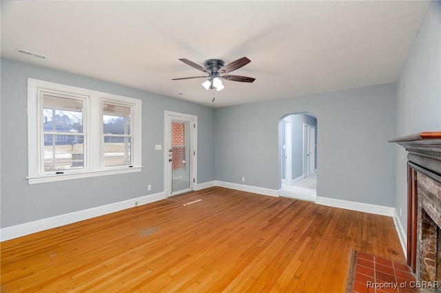 unfurnished living room with ceiling fan and light wood-type flooring