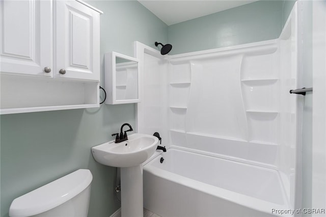 full bathroom featuring sink, tub / shower combination, and toilet