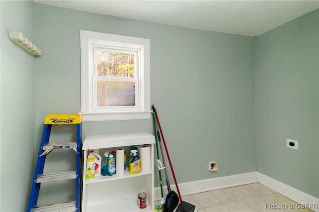 laundry area featuring hookup for an electric dryer and light tile patterned floors