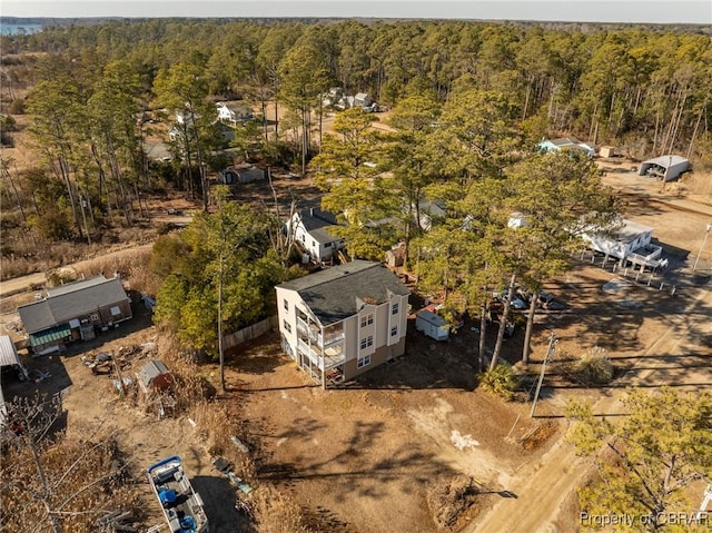 birds eye view of property with a view of trees