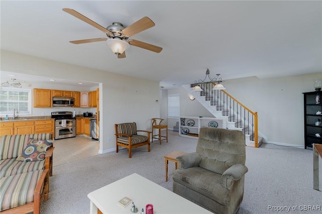 carpeted living room featuring sink and ceiling fan