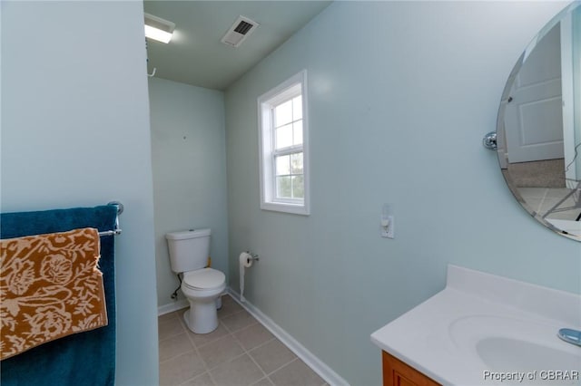 bathroom with vanity, baseboards, toilet, tile patterned flooring, and visible vents