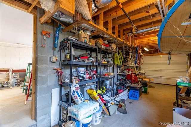 garage featuring concrete block wall and a workshop area