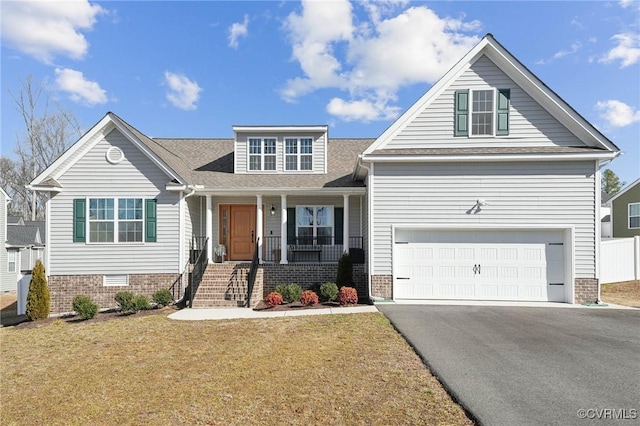 view of front of house featuring a garage, a porch, and a front lawn