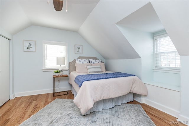 bedroom featuring vaulted ceiling, ceiling fan, and light hardwood / wood-style flooring