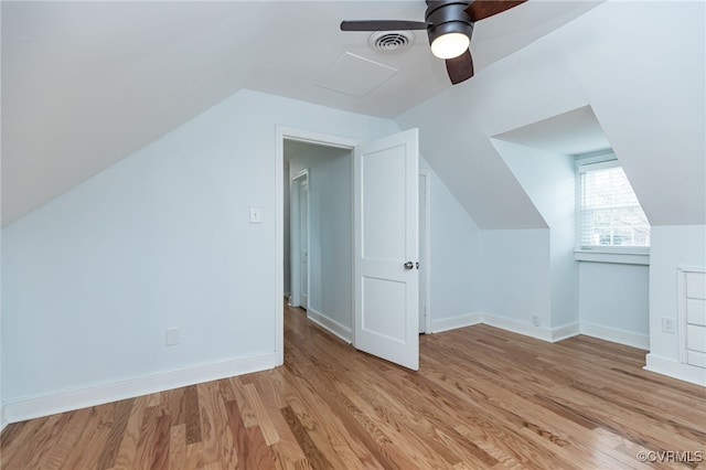 bonus room with lofted ceiling, light hardwood / wood-style floors, and ceiling fan