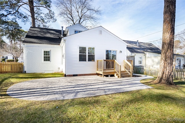 rear view of property with a lawn and a patio