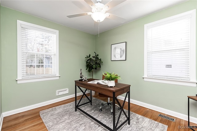 office space with hardwood / wood-style floors and ceiling fan