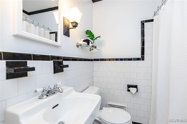 bathroom with sink, tile walls, a shower with shower curtain, and toilet