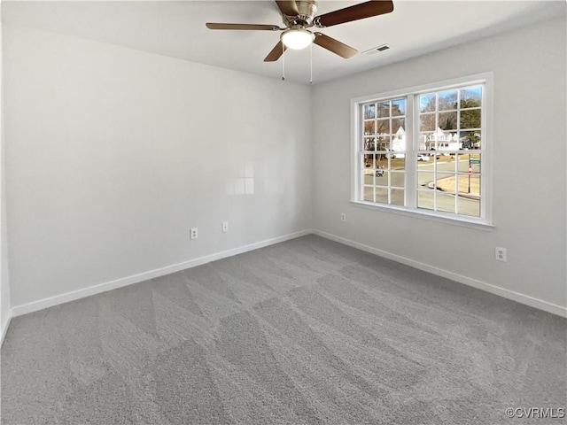 carpeted spare room featuring ceiling fan