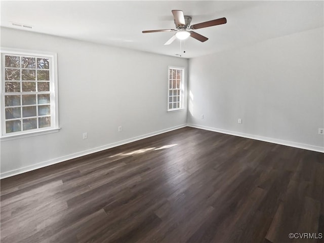 spare room featuring dark hardwood / wood-style floors and ceiling fan