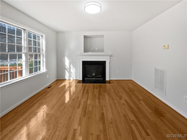 unfurnished living room with hardwood / wood-style floors