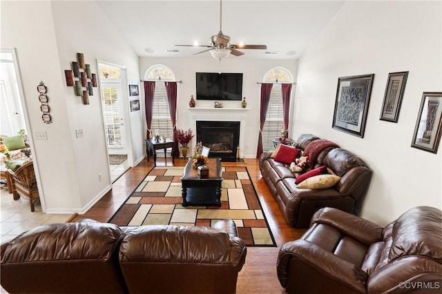 living room featuring vaulted ceiling and ceiling fan