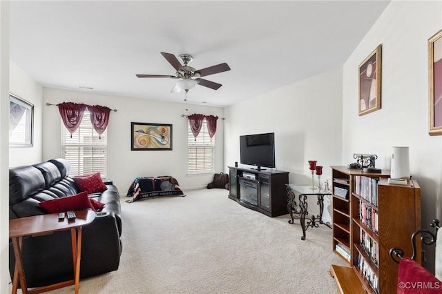 carpeted living room with ceiling fan and plenty of natural light