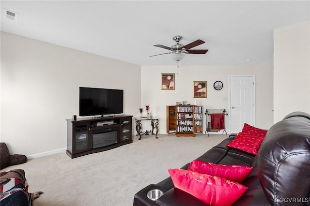 carpeted living room featuring ceiling fan