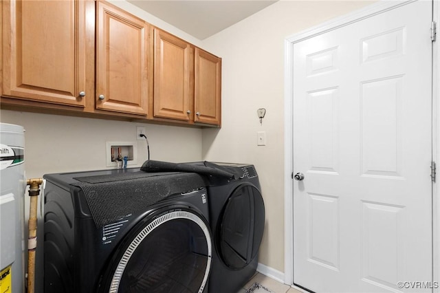 laundry room featuring washer and dryer and cabinets