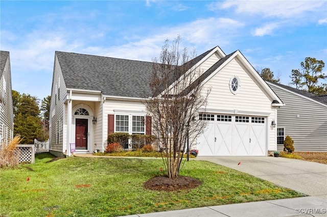 view of front of property featuring a garage and a front lawn