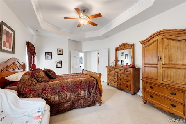 carpeted bedroom with crown molding, a raised ceiling, and ceiling fan