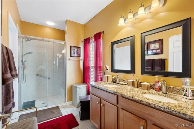 bathroom with tile patterned floors, a shower with shower door, and vanity