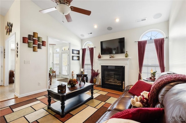 living room with lofted ceiling, ceiling fan, and light hardwood / wood-style flooring