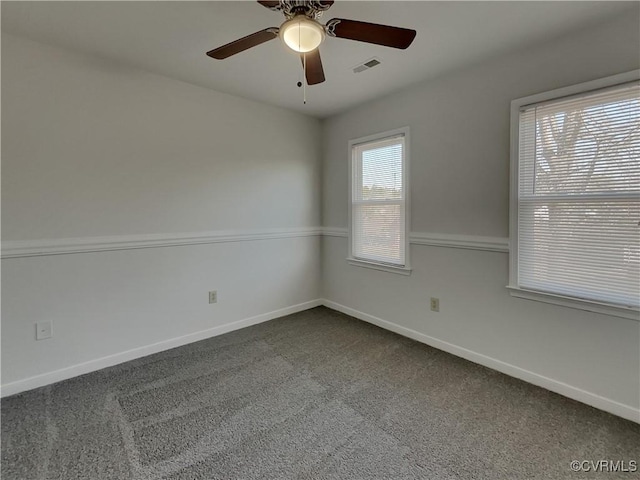 carpeted spare room featuring ceiling fan