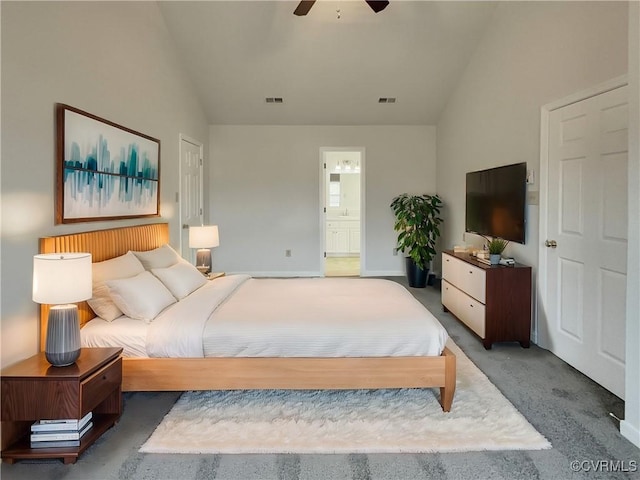 carpeted bedroom featuring ceiling fan, connected bathroom, and vaulted ceiling