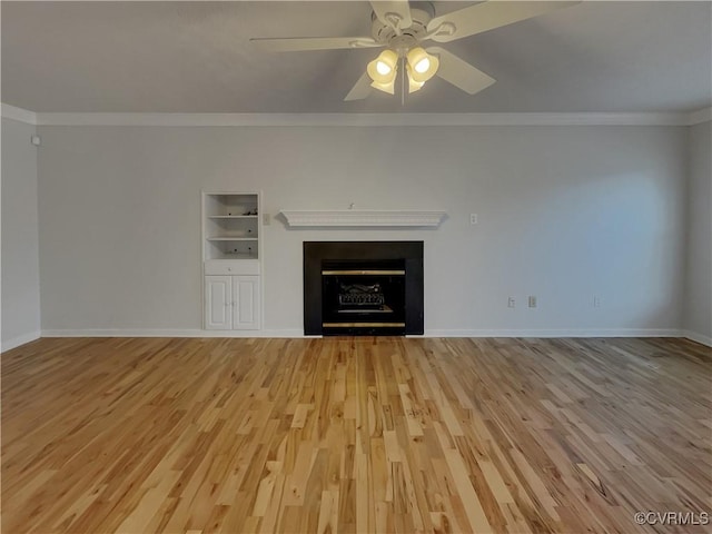 unfurnished living room featuring ornamental molding, built in shelves, ceiling fan, and light hardwood / wood-style flooring