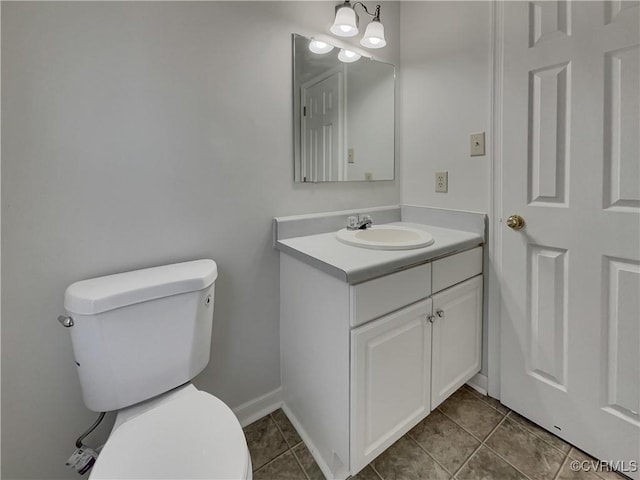 bathroom with vanity, tile patterned floors, and toilet