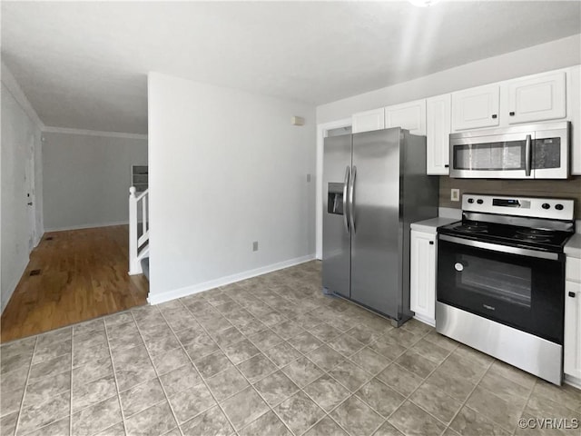 kitchen featuring white cabinetry, crown molding, and appliances with stainless steel finishes