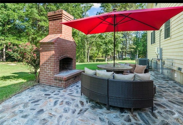 25 Cow Shed Rd, Lancaster, VA 22503 - view of patio featuring central AC, an outdoor living space with a fireplace, and view of wooded area