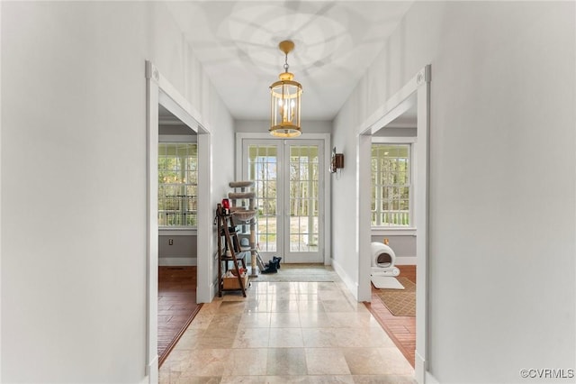 25 Cow Shed Rd, Lancaster, VA 22503 - foyer entrance featuring baseboards, a chandelier, light tile patterned floors, and french doors
