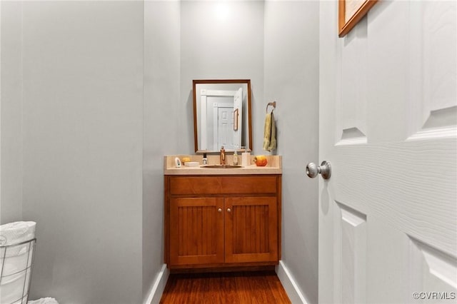 25 Cow Shed Rd, Lancaster, VA 22503 - half bathroom with wood finished floors, baseboards, vanity, and toilet