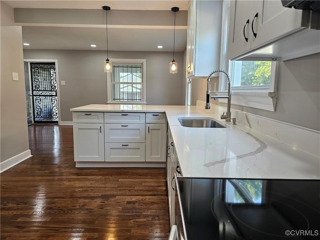 kitchen featuring sink, pendant lighting, white cabinets, and dark hardwood / wood-style flooring