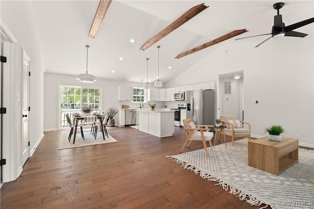 kitchen featuring a kitchen island, appliances with stainless steel finishes, decorative light fixtures, white cabinetry, and dark hardwood / wood-style flooring