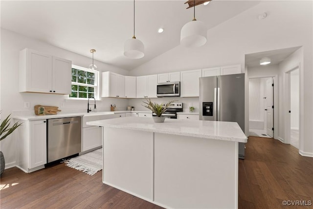 kitchen with pendant lighting, white cabinetry, and appliances with stainless steel finishes