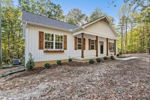 view of front of home with a porch and central air condition unit