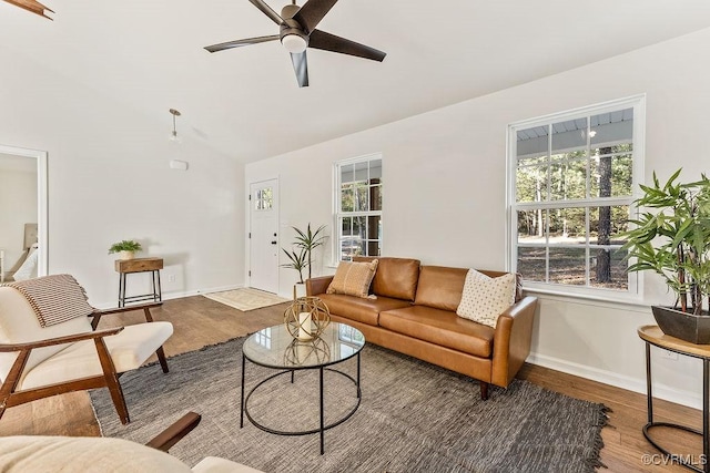 living room featuring hardwood / wood-style flooring, lofted ceiling, a healthy amount of sunlight, and ceiling fan