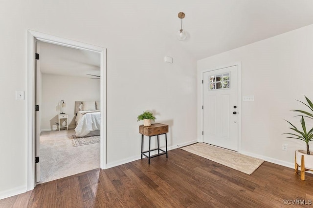 entrance foyer with dark hardwood / wood-style flooring and lofted ceiling