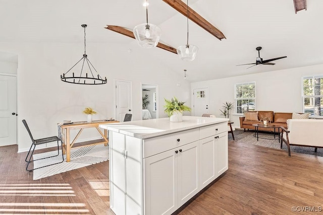 kitchen featuring ceiling fan, hanging light fixtures, hardwood / wood-style floors, a center island, and white cabinets