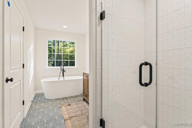 bathroom featuring vanity and separate shower and tub