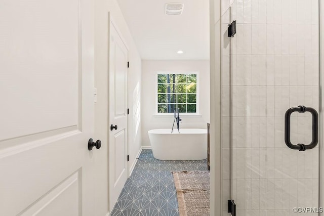 bathroom with separate shower and tub