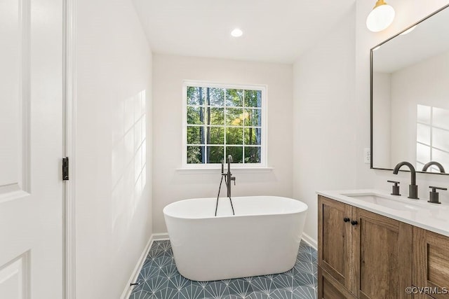 bathroom with vanity and a tub