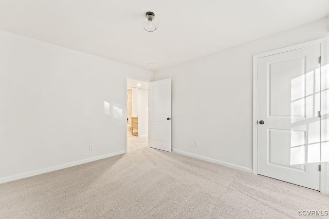 unfurnished room featuring light colored carpet