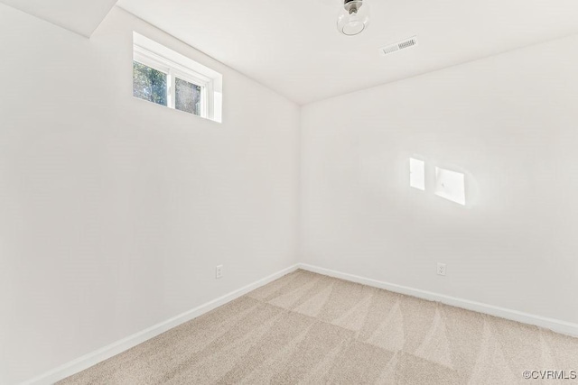 unfurnished room with lofted ceiling and carpet floors