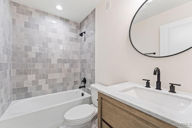 full bathroom featuring vanity, toilet, and tiled shower / bath combo