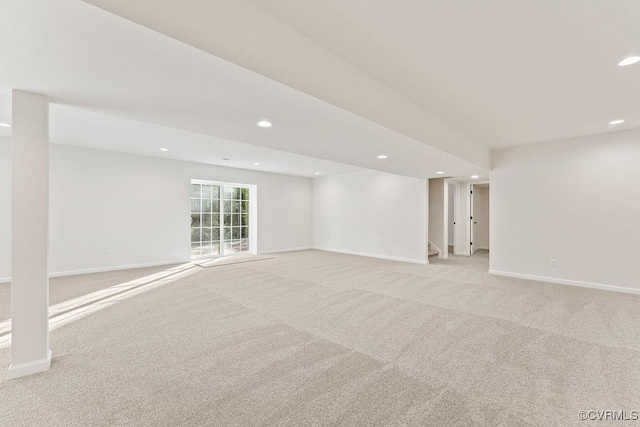 basement featuring light colored carpet