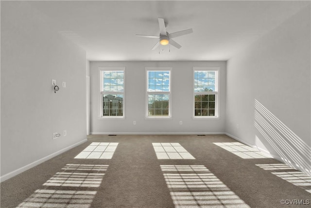 spare room featuring carpet and ceiling fan